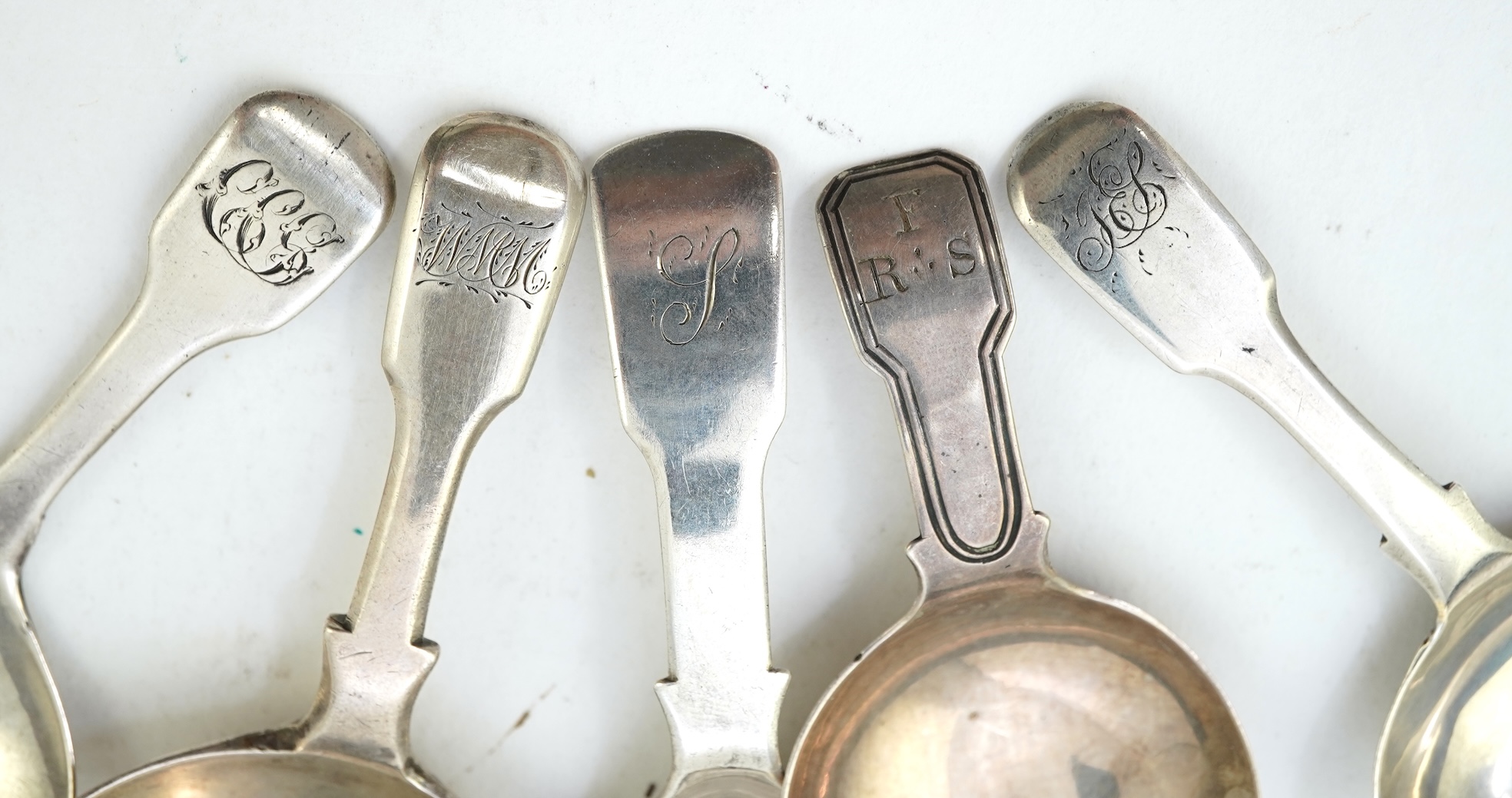 A collection of ten assorted mainly 19th century silver and white metal fiddle pattern caddy spoons